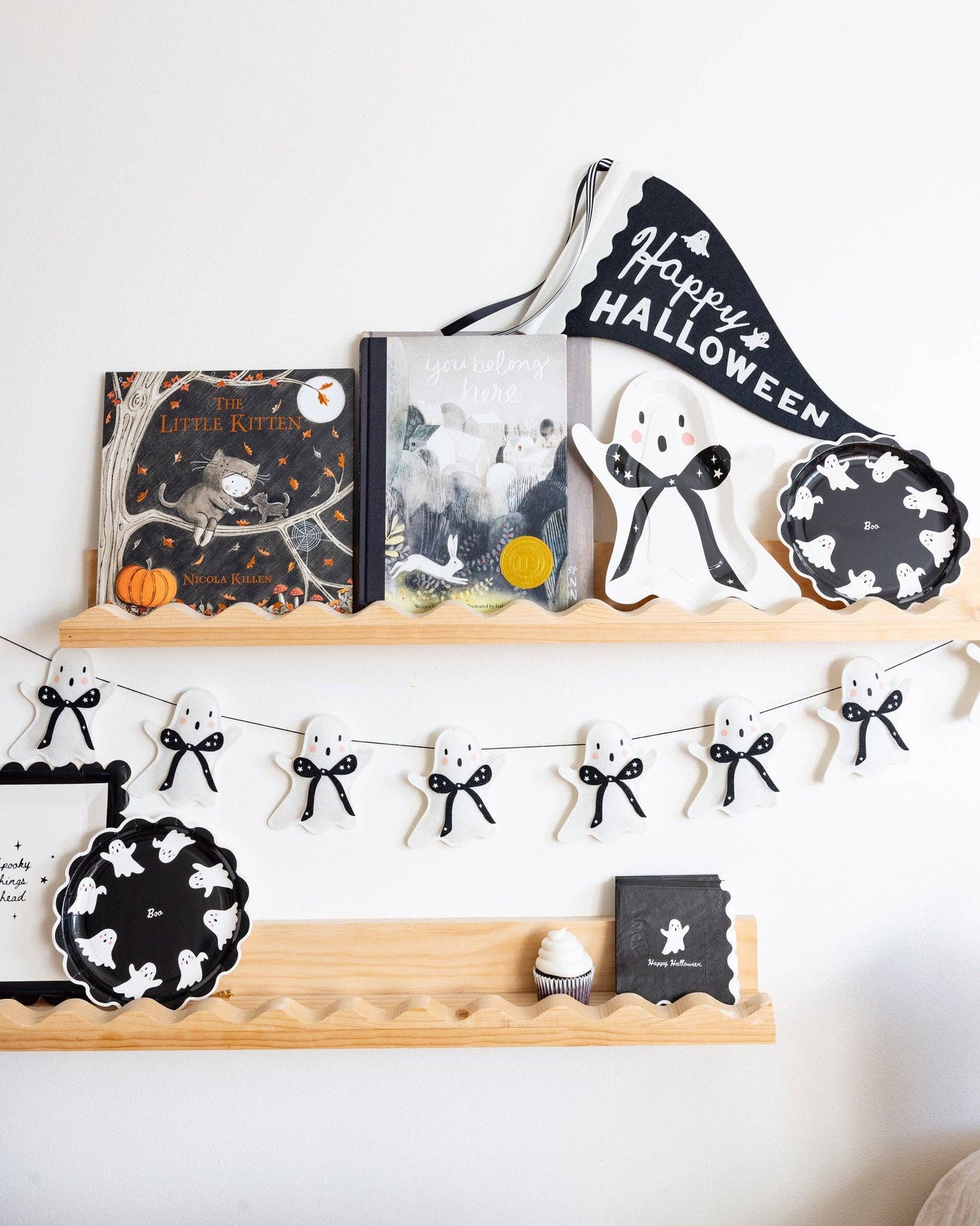 Ghost felt Halloween banner styled with black and white Halloween party decor