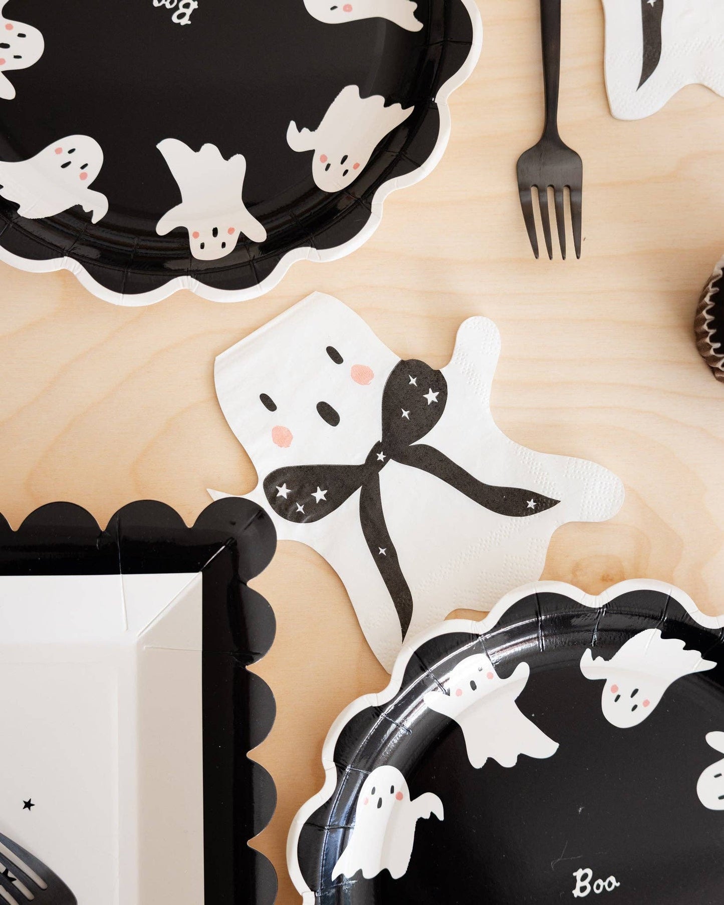 Ghost shaped Halloween cocktail napkins styled with party tableware