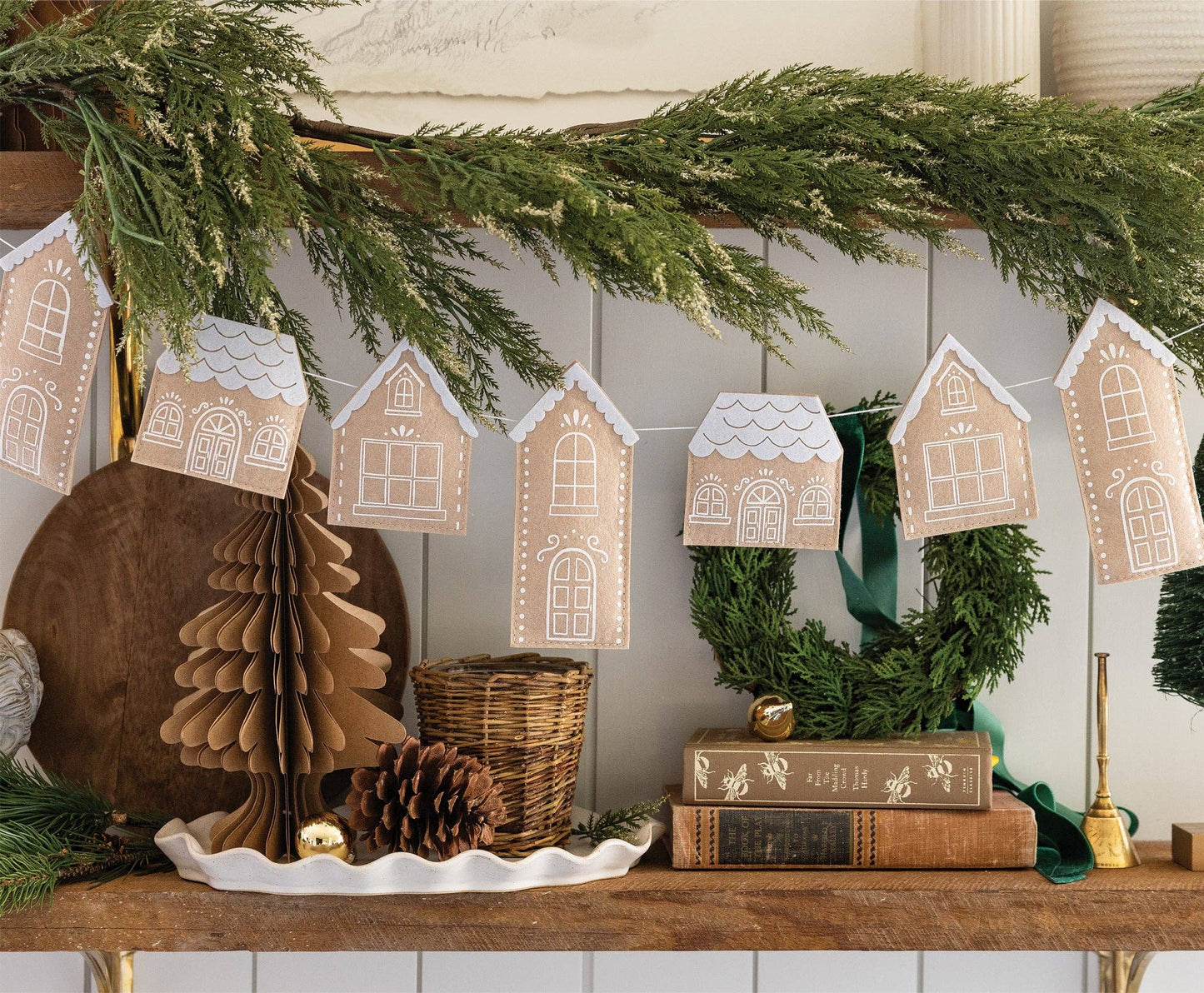 Holiday party setup with gingerbread felt houses banner, red accents, and Christmas decor available across Canada.