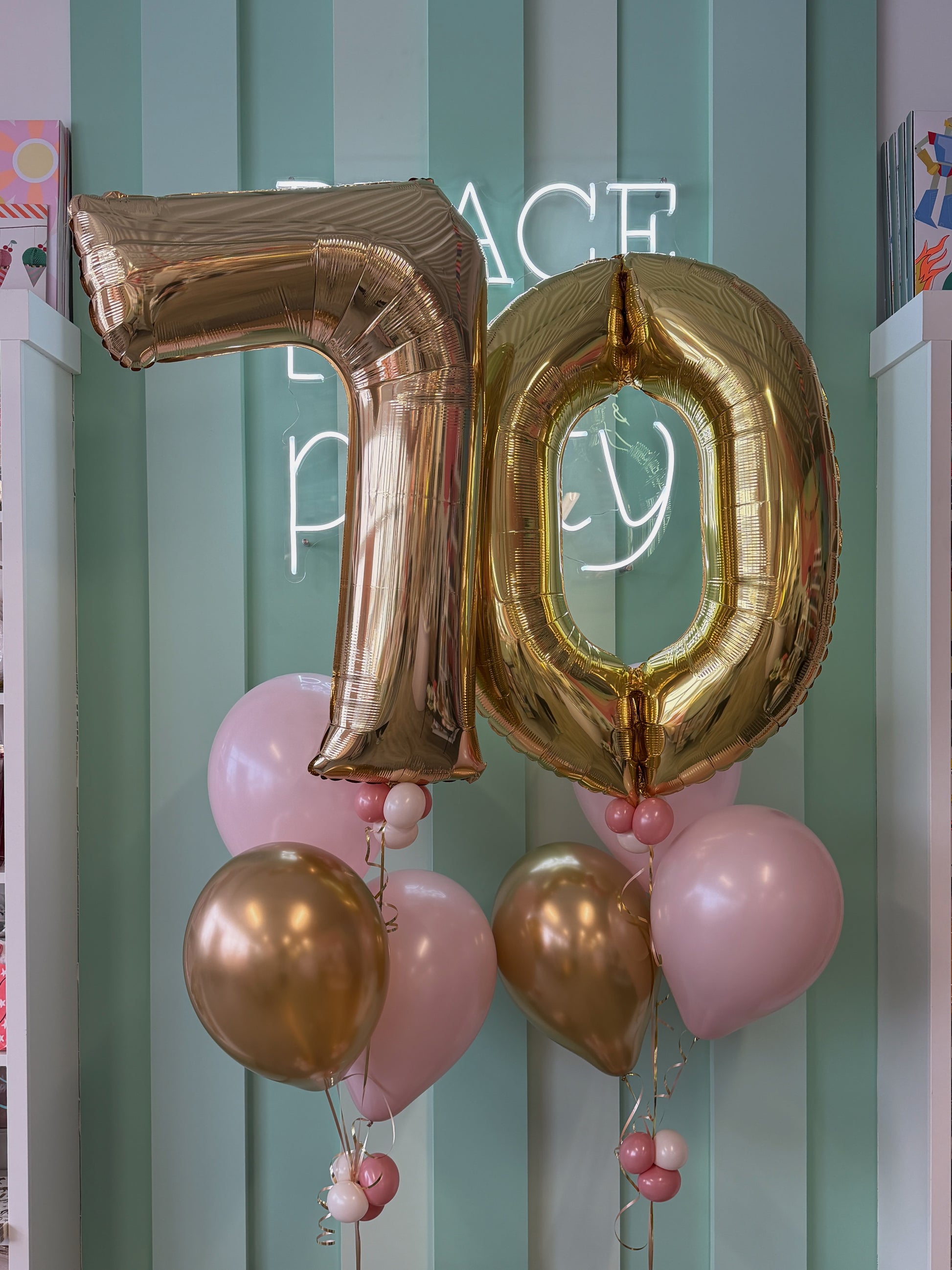 Close-up of gold 70 foil number balloons with coordinating pink, blush and gold helium balloons for Toronto milestone birthdays.