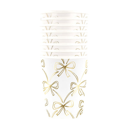 tack of Meri Meri gold bow cups, perfect for elegant parties and celebrations in Toronto.