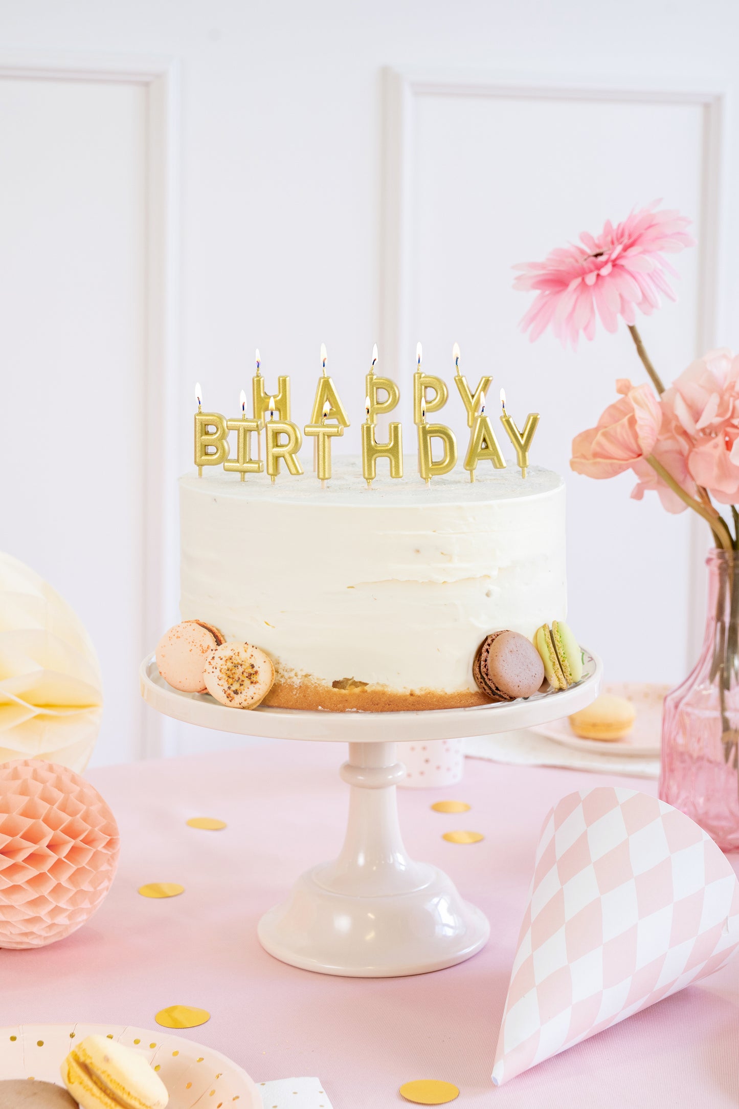 Gold Happy Birthday candles styled on a birthday cake available at our Toronto party shop