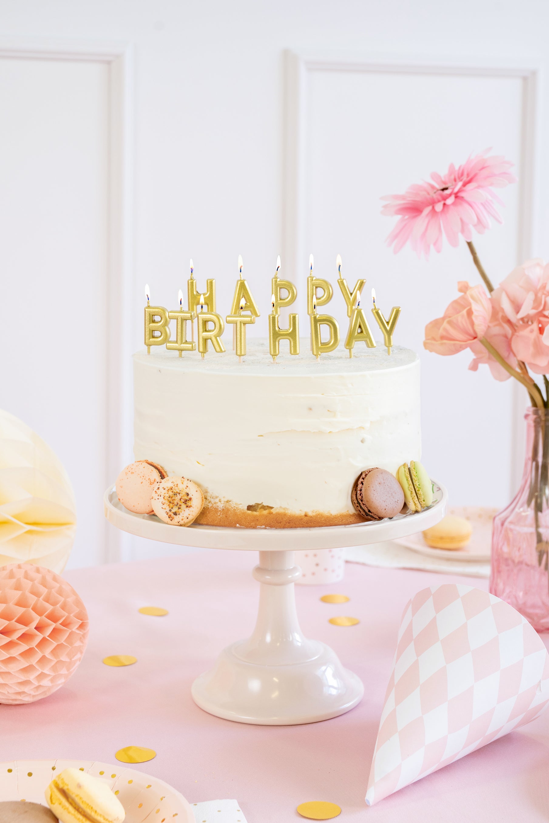 Gold Happy Birthday candles styled on a birthday cake available at our Toronto party shop