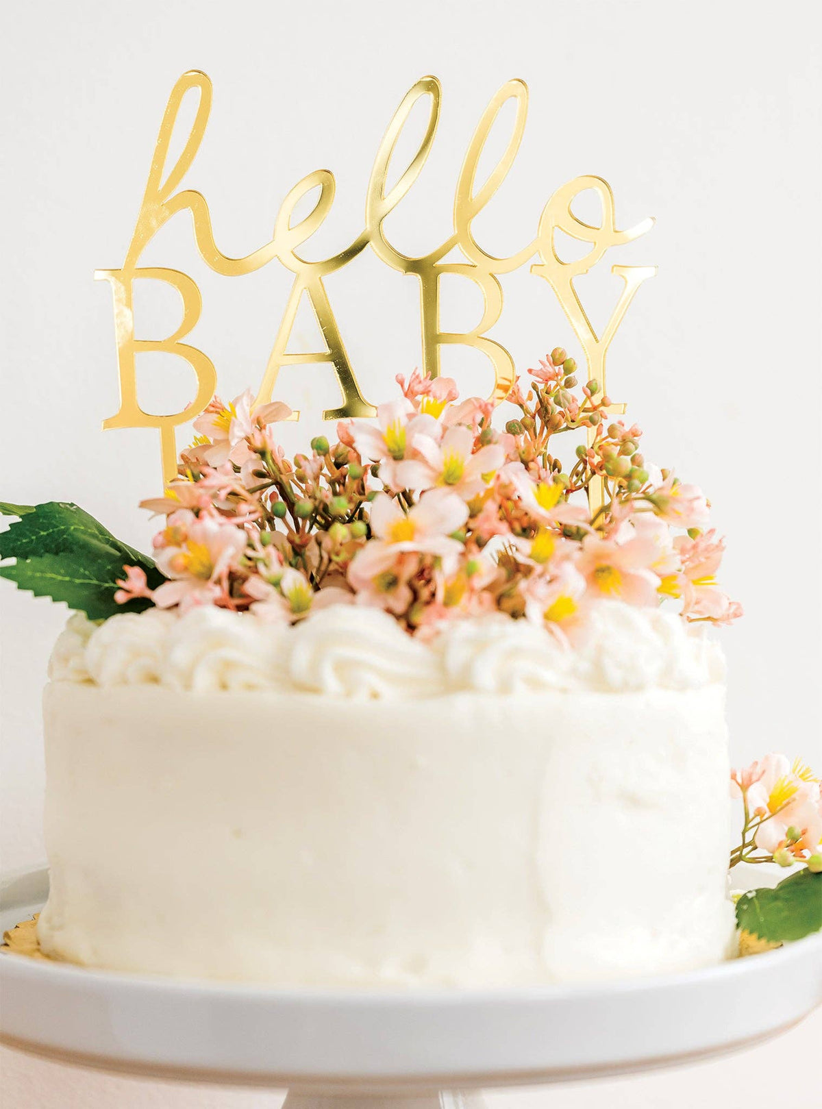 Gold Hello Baby acrylic cake topper on a baby shower cake