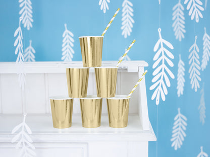 gold cups with gold and white striped straws