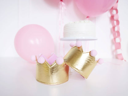 gold princess crown with pink pom poms styled in a pink birthday setup available at our Toronto party shop