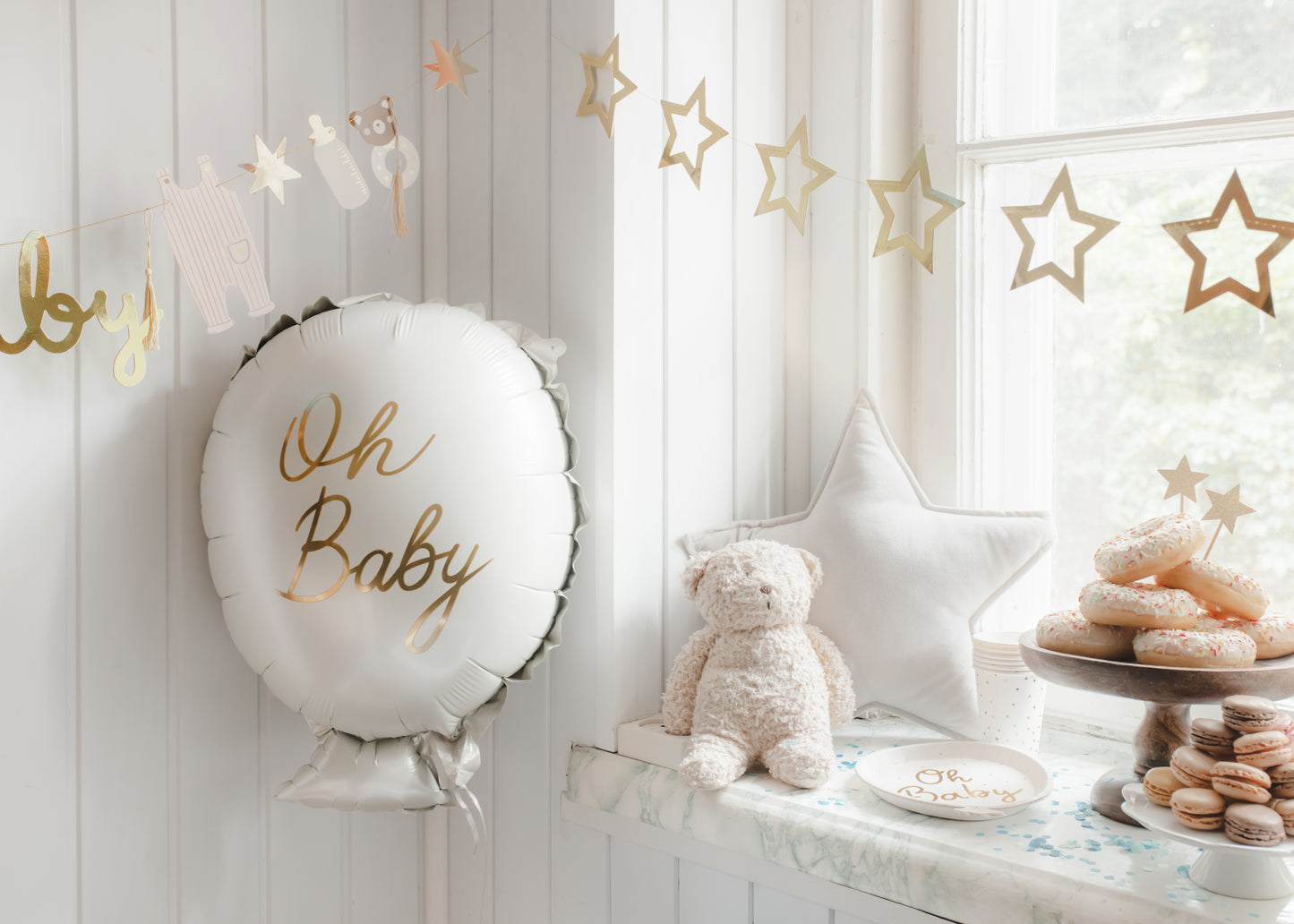Metallic gold star garland styled for a baby shower available at our Toronto party shop
