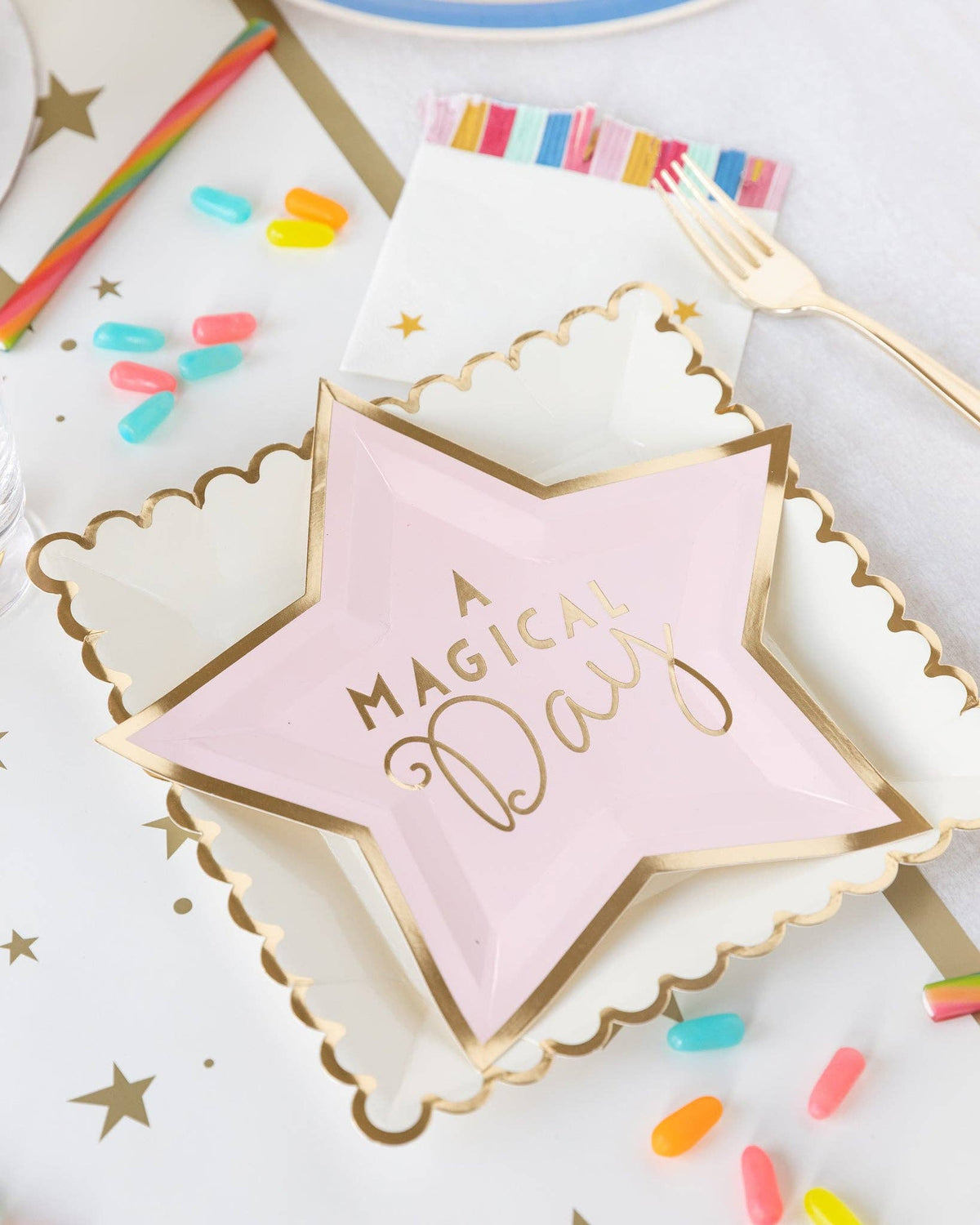 Gold stars paper table runner styled with pink star plates, scalloped gold trim partyware and colourful birthday decorations. Pick up in Toronto + Canada-wide shipping available.
