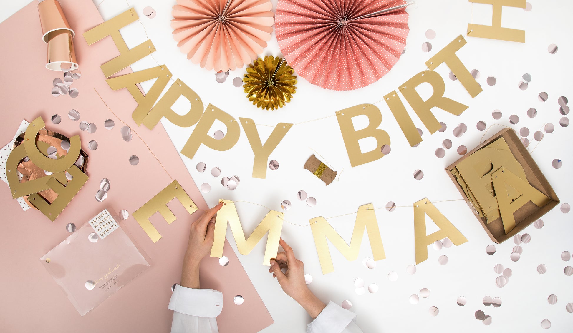 Mirror gold alphabet banner letters being strung on twine with party décor, sold in Toronto at Confetti My Party. Ships across Canada.