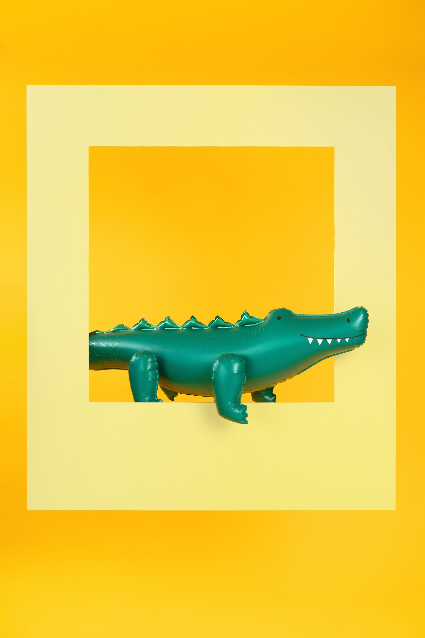 Green crocodile foil balloon styled against a bold yellow backdrop, perfect for modern party decor available at our Toronto party shop.