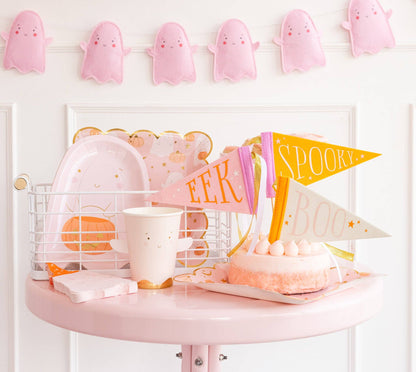 Pink and orange Halloween party table with felt pennant decorations