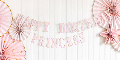 Pink Happy Birthday Princess banner styled with pink paper fans and birthday decorations