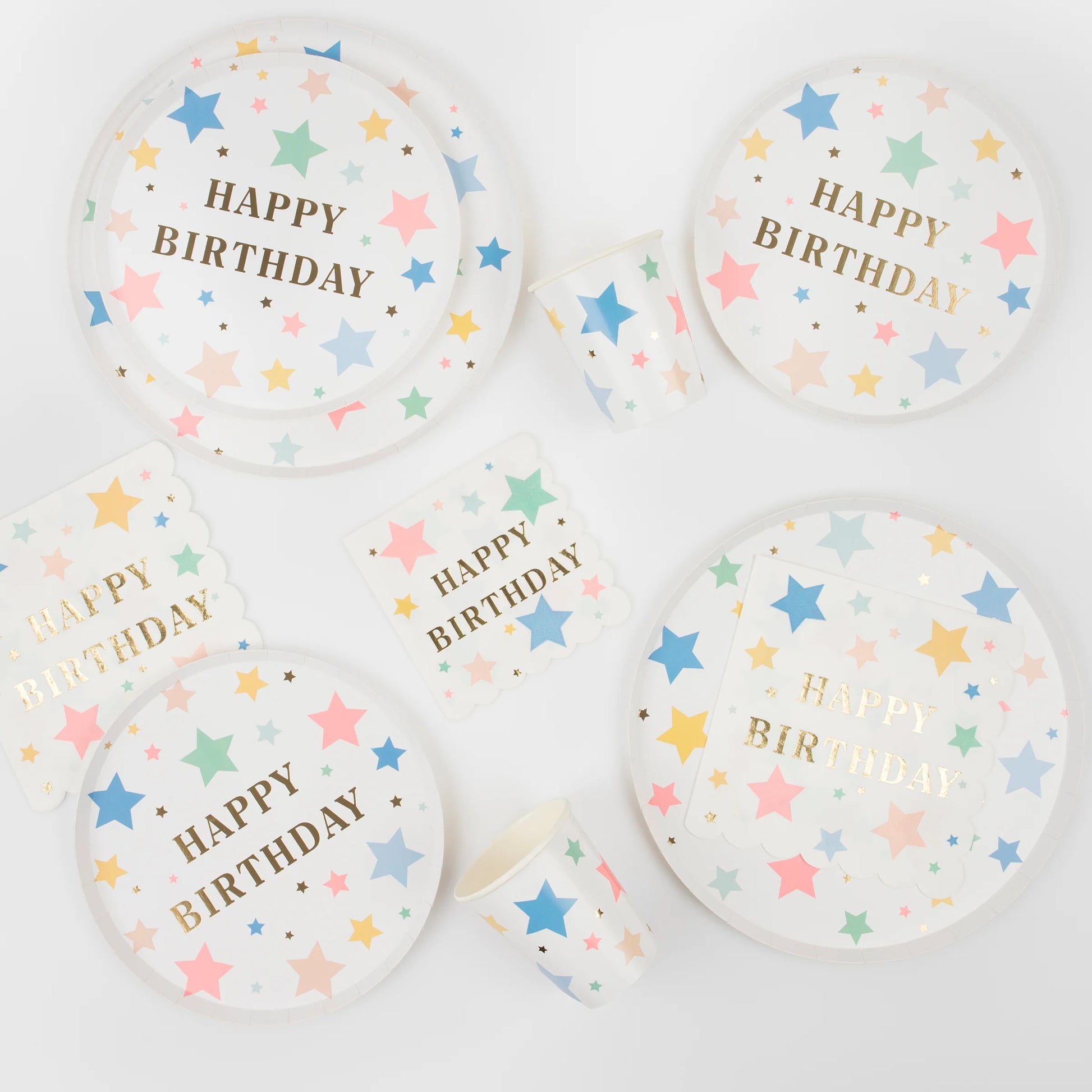 "happy birthday" in gold text birthday plates with colourful star illustrations 