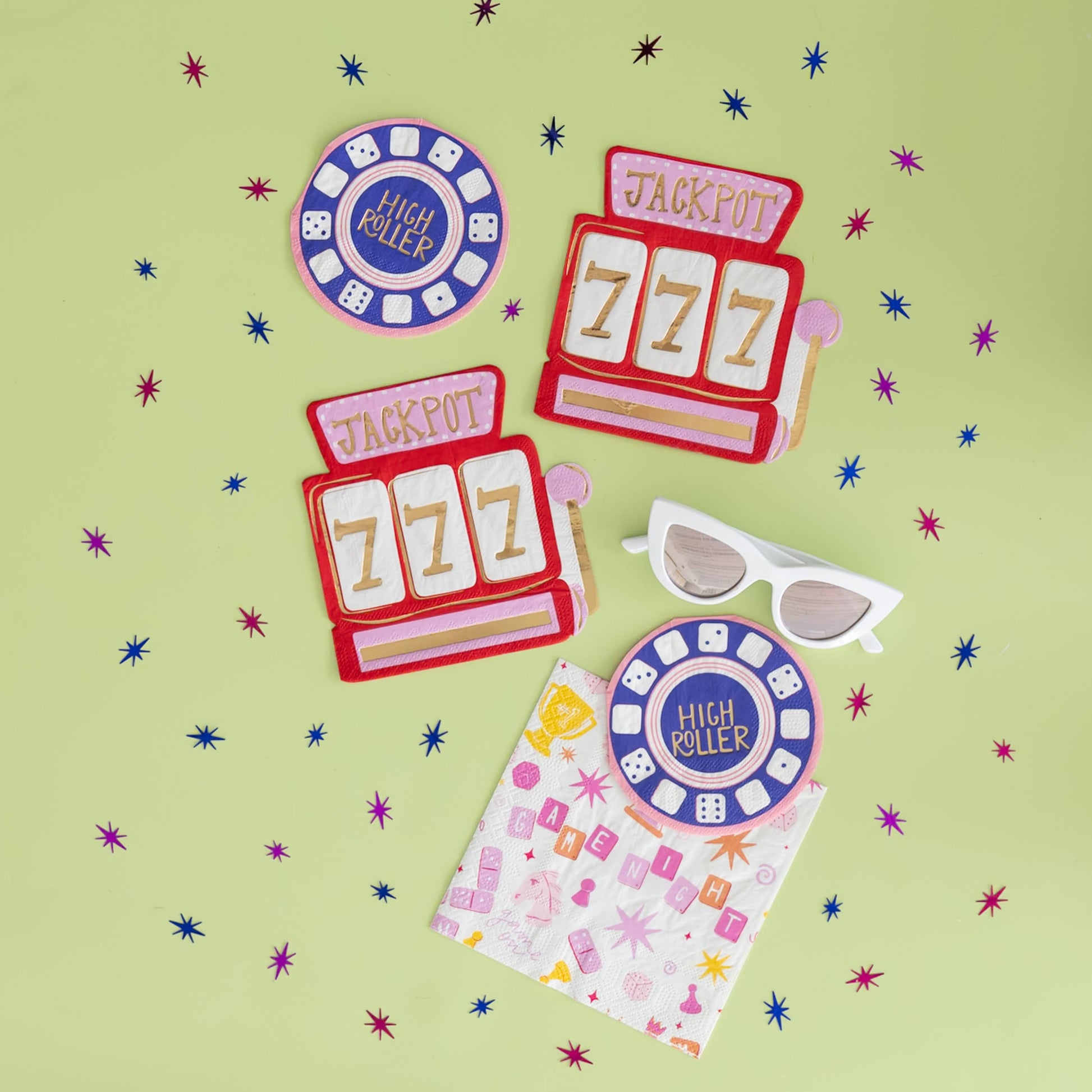Flat lay of High Roller napkins, Jackpot napkins, and Game Night napkins styled on green backdrop, available in Toronto and shipping across Canada.