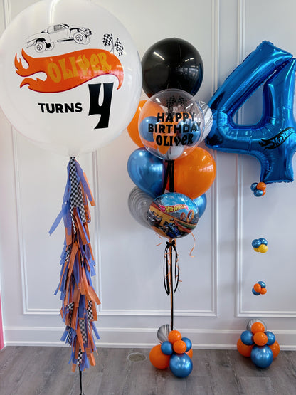 Hot Wheels-inspired birthday balloon package in blue, orange, black + silver with personalized racing balloons.
