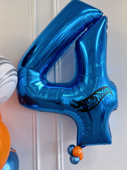 Blue foil number 4 birthday balloon with Hot Wheels-inspired logo and mini balloon detail.