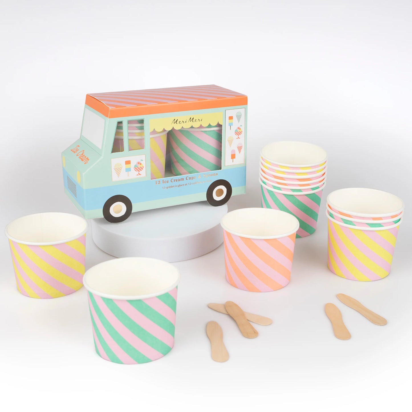 Meri Meri ice cream cups with pastel diagonal stripes and wooden spoons, displayed in front of ice cream truck packaging