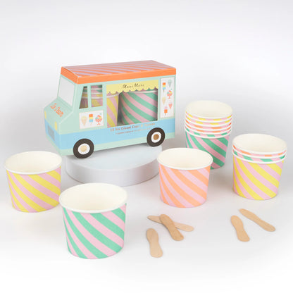 Meri Meri ice cream cups with pastel diagonal stripes and wooden spoons, displayed in front of ice cream truck packaging