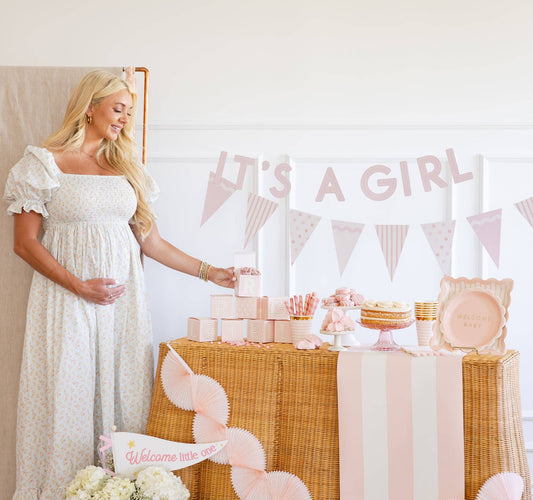 Light pink ‘It’s a Girl’ banner with coordinating baby shower setup in Toronto.