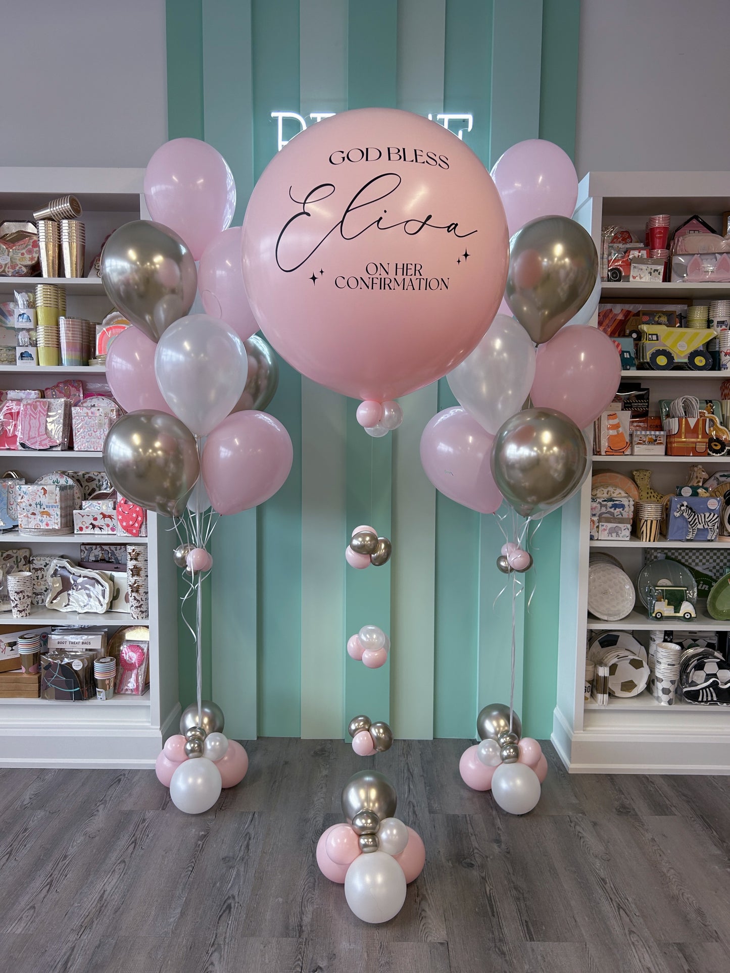 Balloon arch with personalized message in a store setting