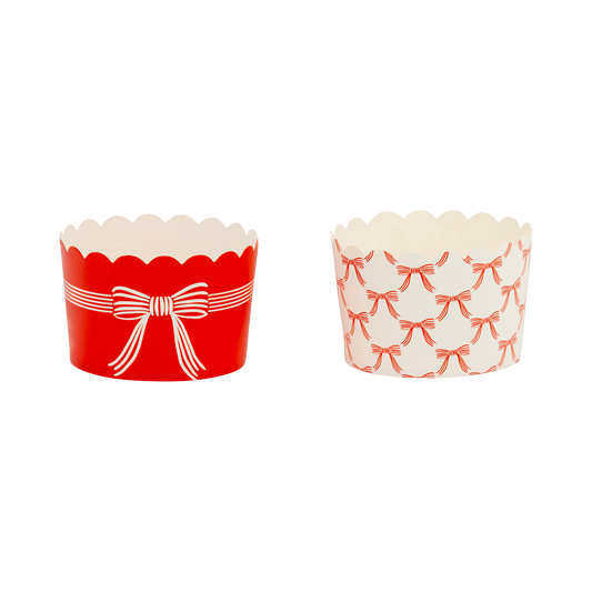 Red and white paper treat cups with bow design, filled with candies, perfect for holiday parties in Toronto.