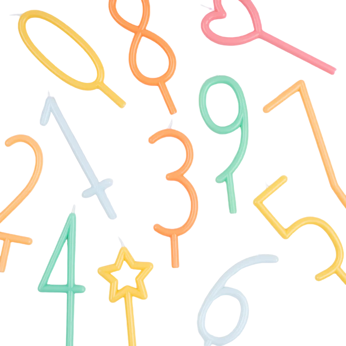 A set of colorful novelty birthday candles shaped like numbers and symbols, including 1 through 9, hearts, a star wand, and an oval, scattered on a plain white background.