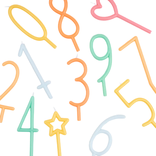 A set of colorful novelty birthday candles shaped like numbers and symbols, including 1 through 9, hearts, a star wand, and an oval, scattered on a plain white background.