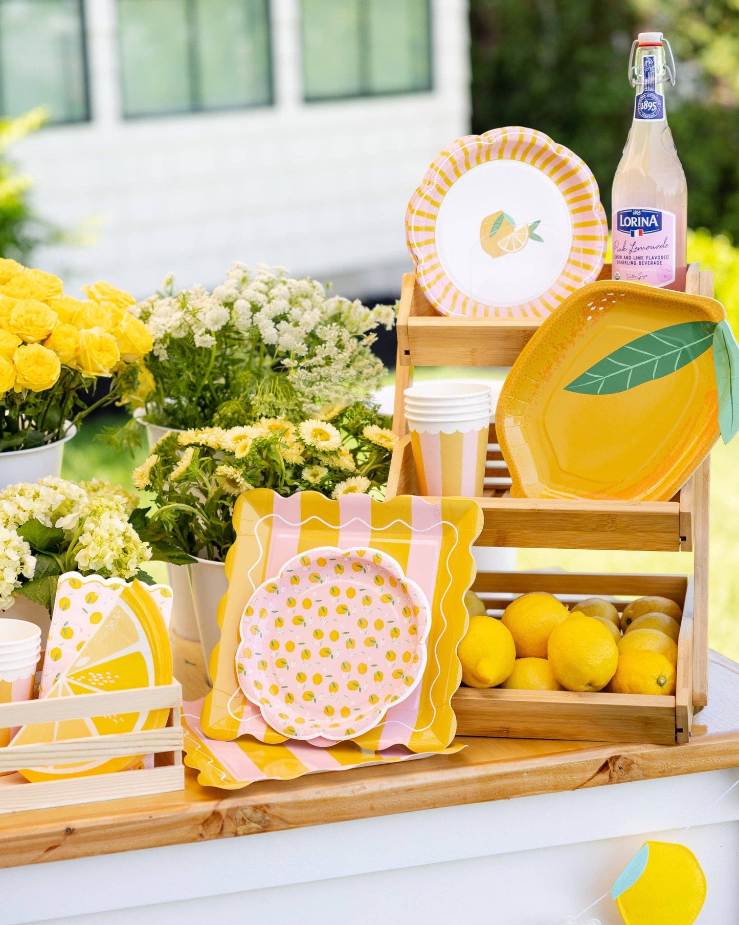 Toronto outdoor party table with lemon-shaped plates, citrus designs, and fresh flowers for a bright summer celebration.