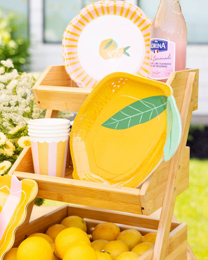 Lemon-themed table display featuring lemon-shaped plates, striped cups, and floral accents — perfect for summer parties, shipping across Canada.