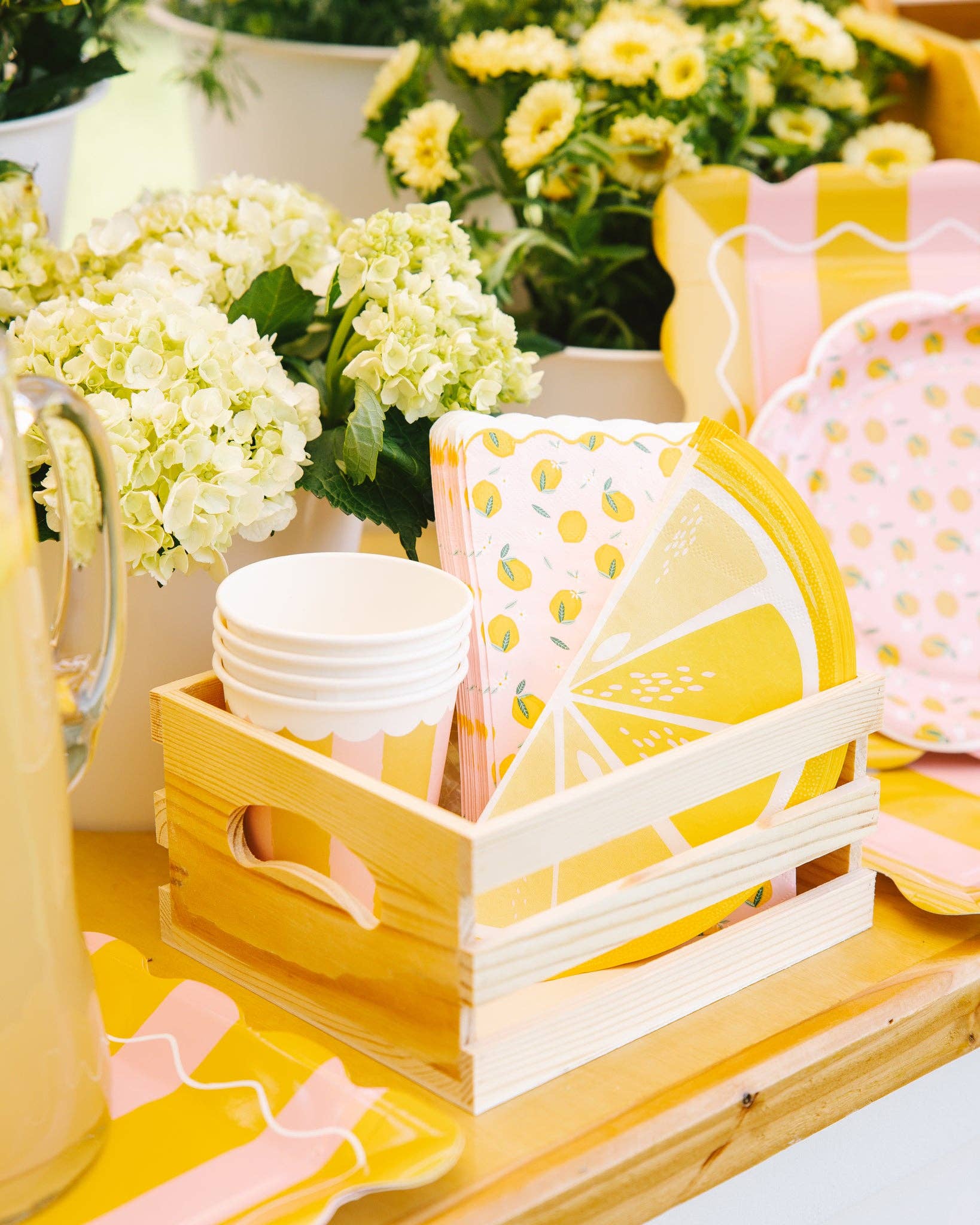 Lemon-themed napkins styled on a bright picnic table with matching plates and cups Sold in Toronto, fast shipping Canada wide.