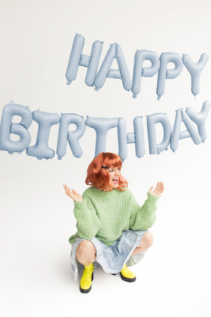 light blue matte happy birthday letters with model posing in front 
