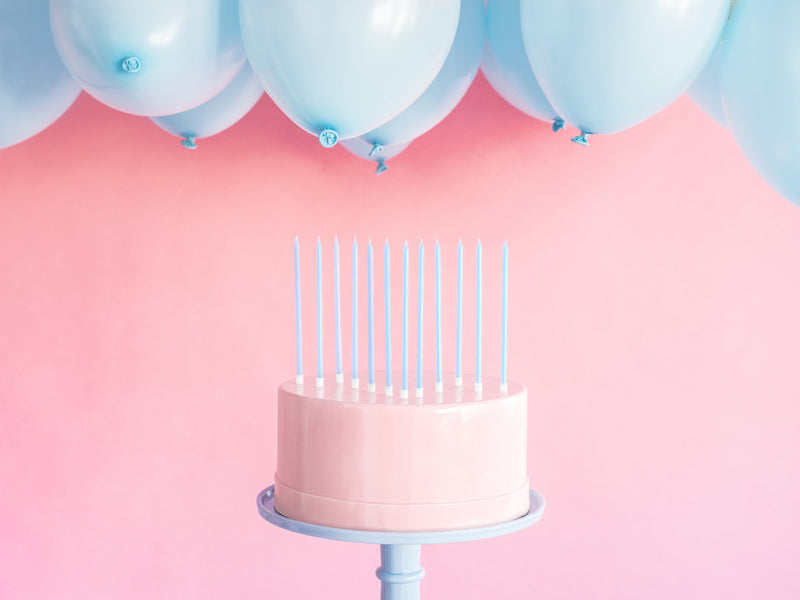 blue candles on a pink cake