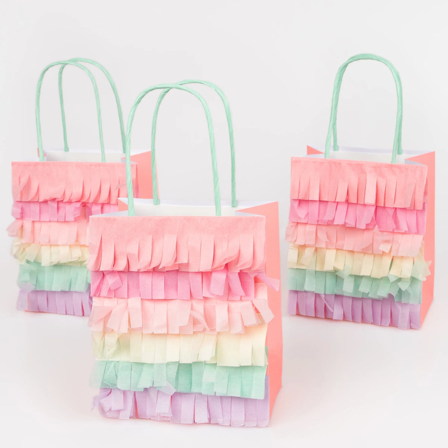 Set of pastel rainbow fringe party bags with mint handles and layered tissue details