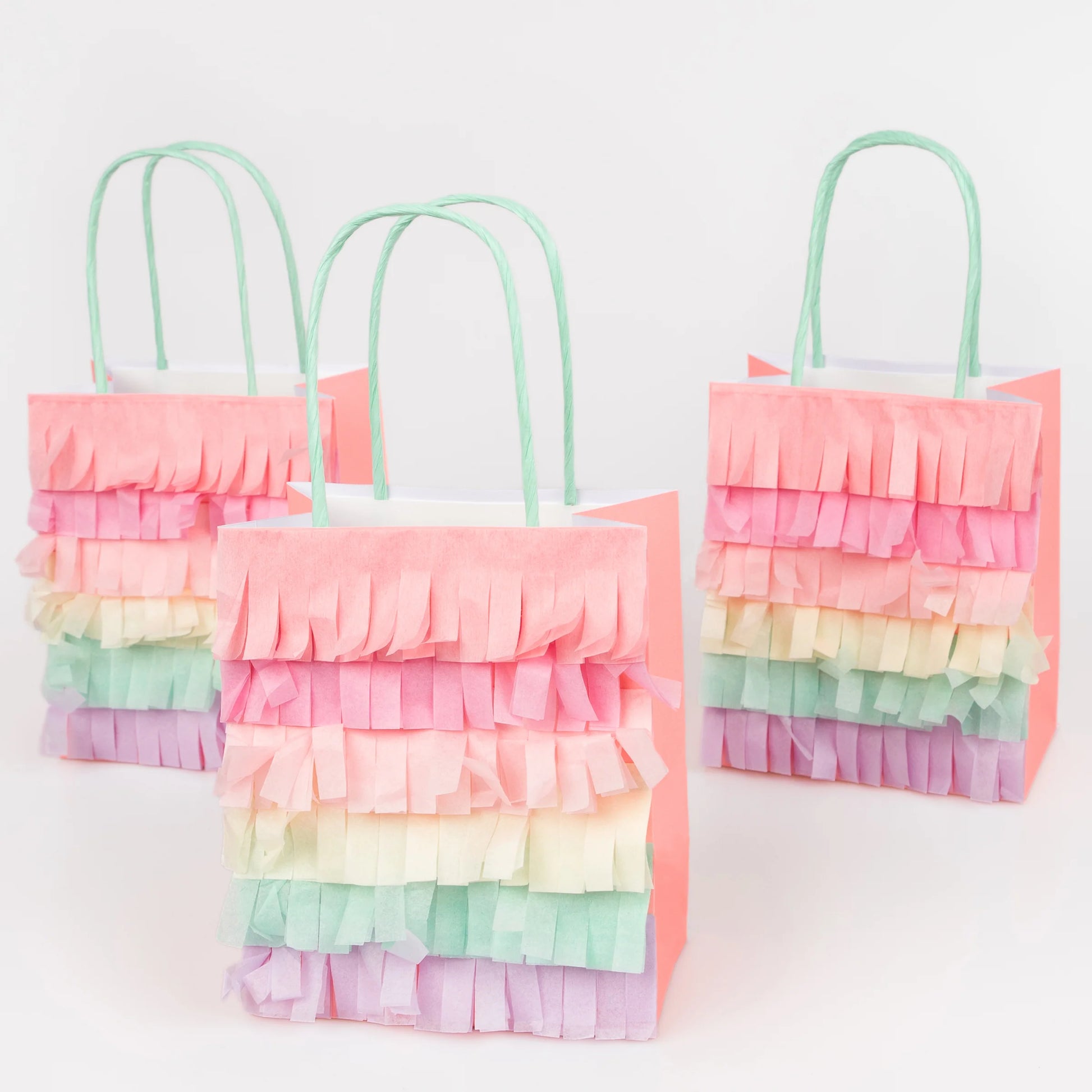 Set of pastel rainbow fringe party bags with mint handles and layered tissue details