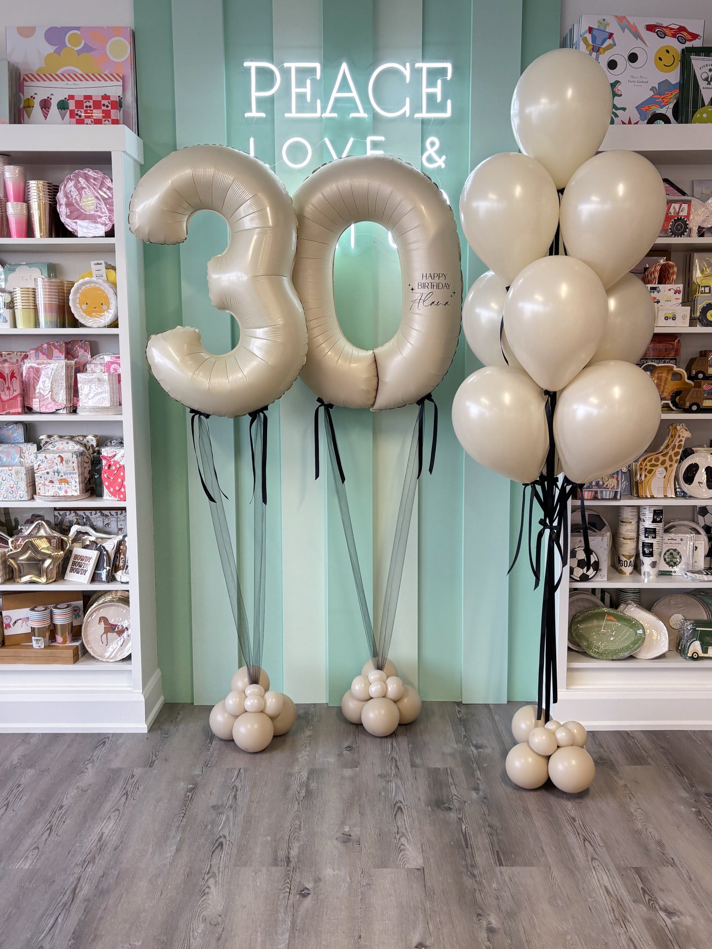 Close-up of a neutral number balloon with a personalised birthday message, part of a milestone balloon setup by Confetti My Party.