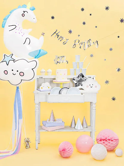 unicorn themed birthday set up with silver happy birthday banner