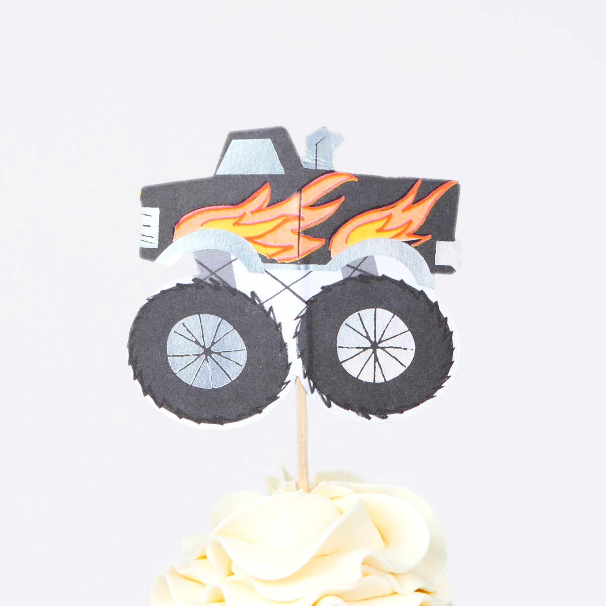 Meri Meri monster truck cupcake topper with flames and large wheels, sold in Toronto at Confetti My Party.