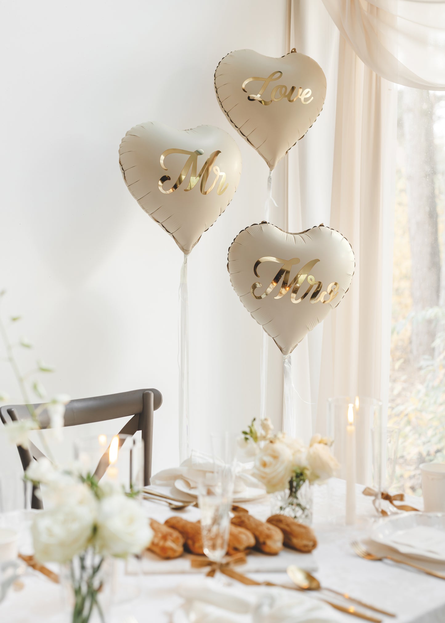 Elegant Mr and Mrs heart balloons styled beside a wedding reception table available at our Toronto party shop