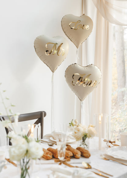 Elegant Mr and Mrs heart balloons styled beside a wedding reception table available at our Toronto party shop