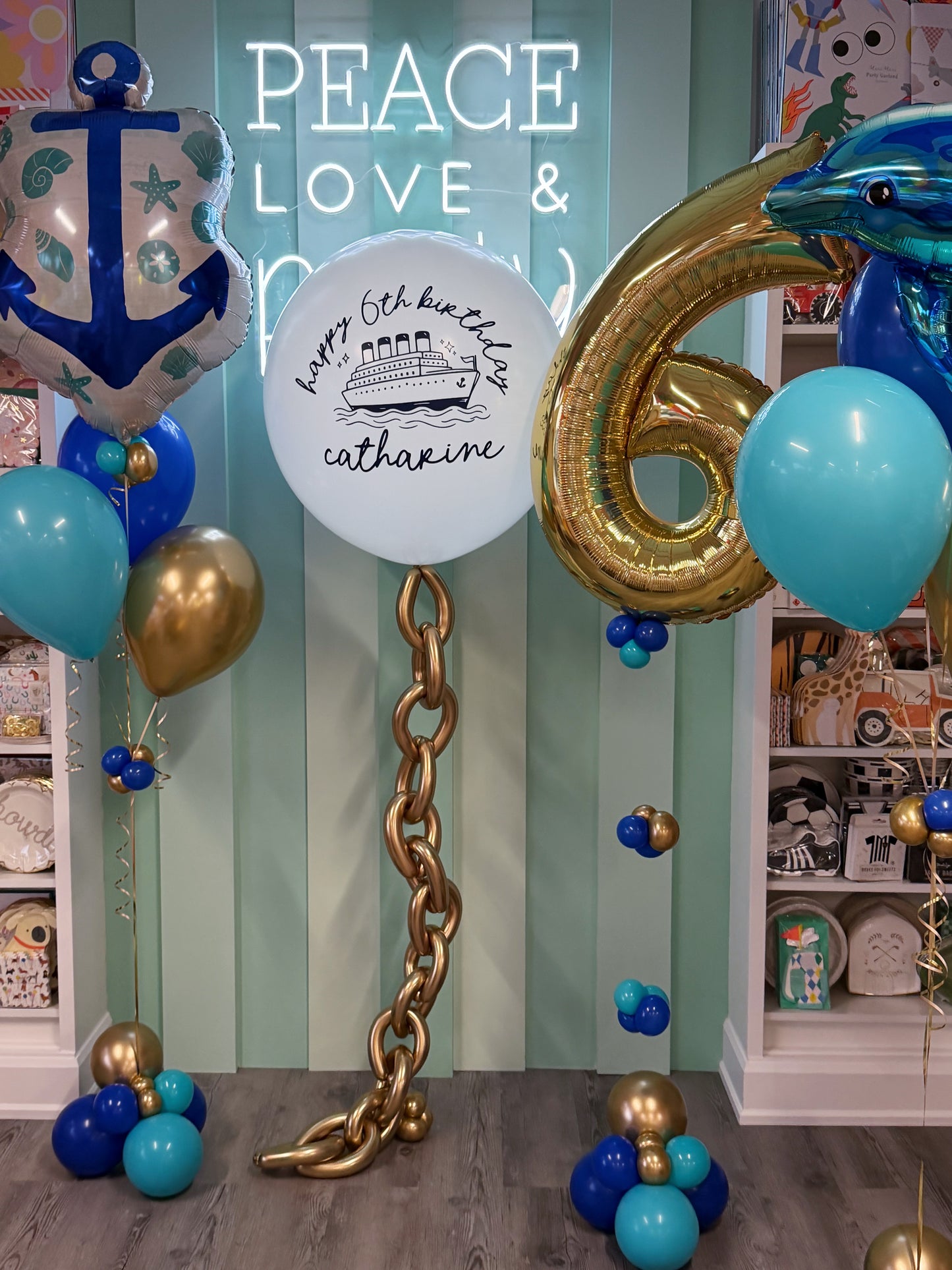 Nautical kids birthday balloon bundle with personalized jumbo balloon, anchor, gold age balloon and blue ocean-themed balloons in Toronto.