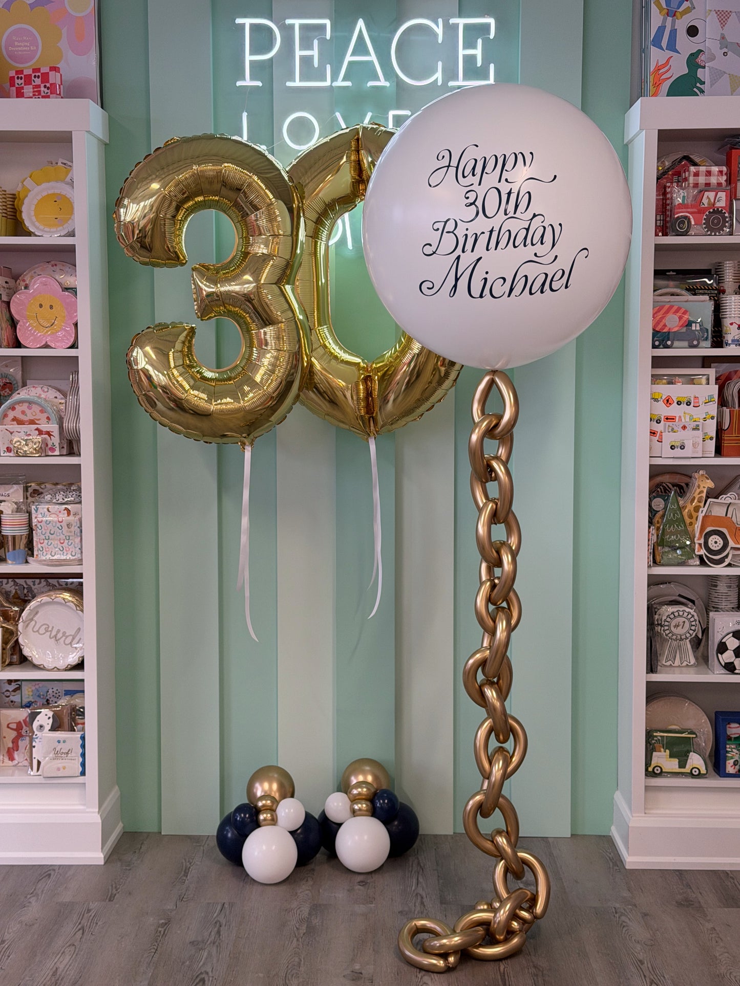 Navy, white and gold nautical birthday balloon bundle with personalized jumbo balloon, white gold number balloons and statement balloon chain in Toronto.