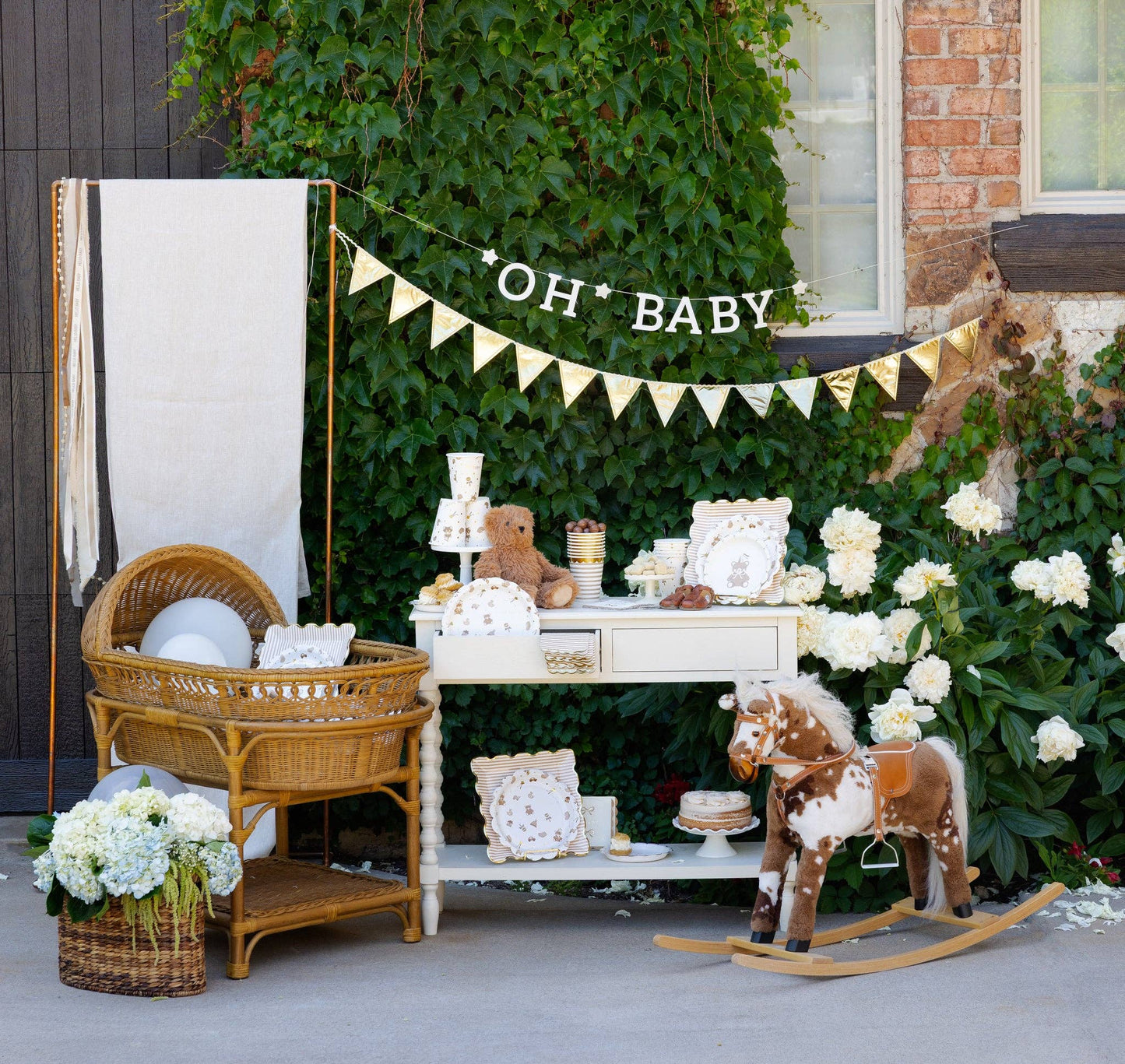 Baby shower setup with a crib, table, and decorations outdoors.