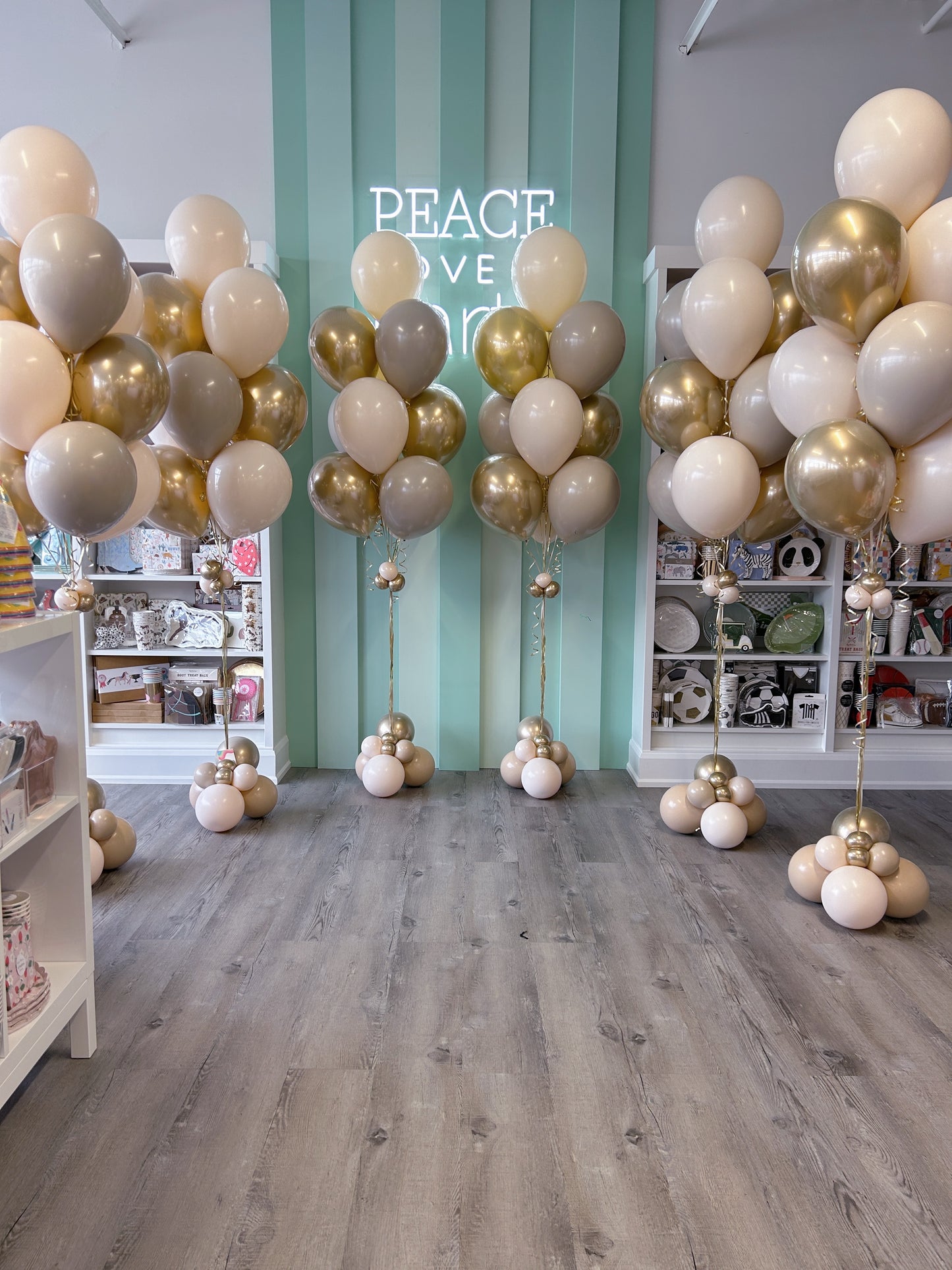 Neutral luxe balloon bundless in ivory, beige, taupe, and gold styled in store, available in Toronto from Confetti My Party