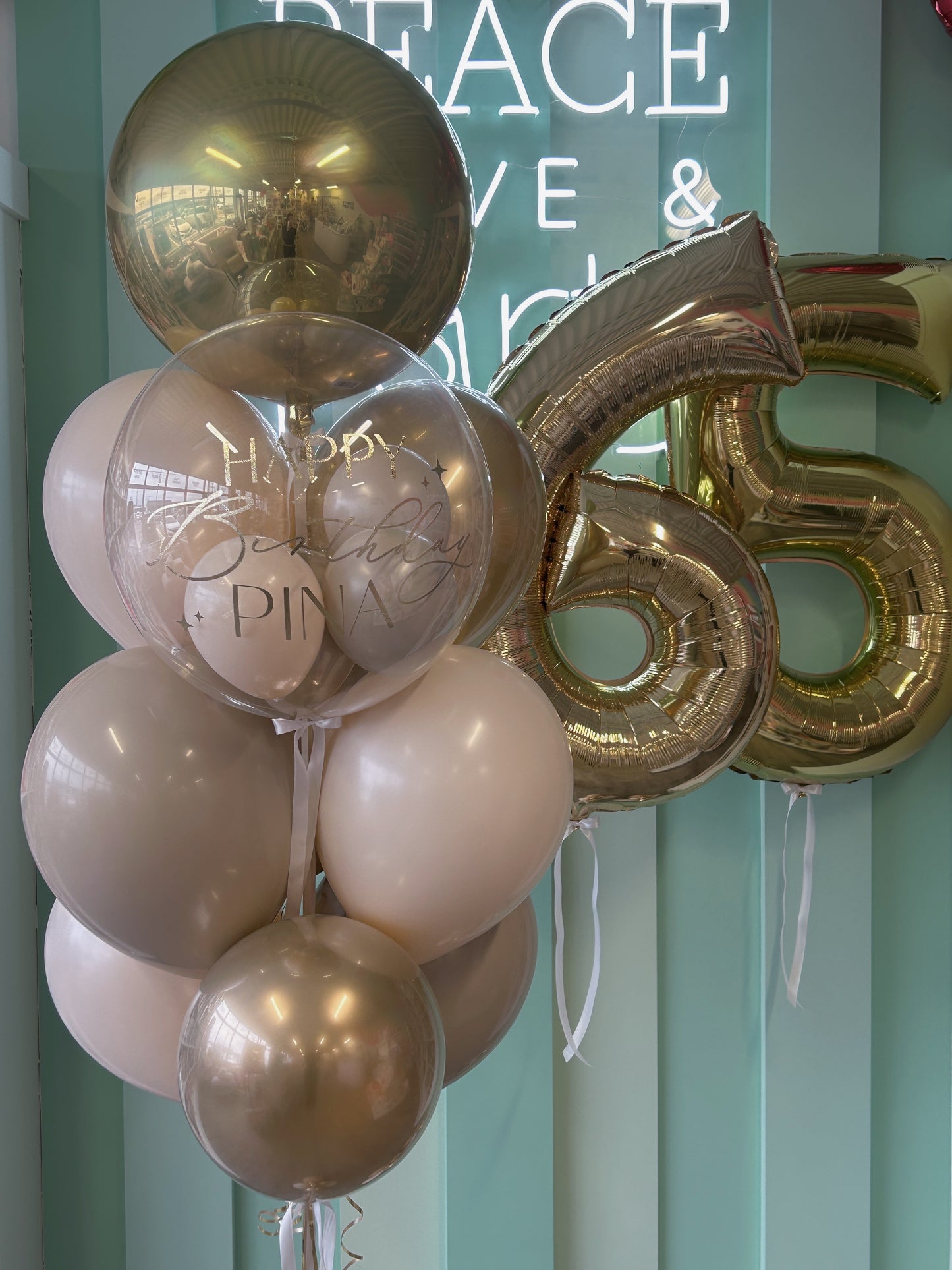 Neutral luxe birthday balloon column paired with gold jumbo number balloons, available in Toronto from Confetti My Party