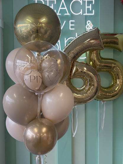 Neutral luxe birthday balloon column paired with gold jumbo number balloons, available in Toronto from Confetti My Party