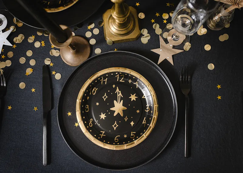 black and gold clock plates new years 2024
