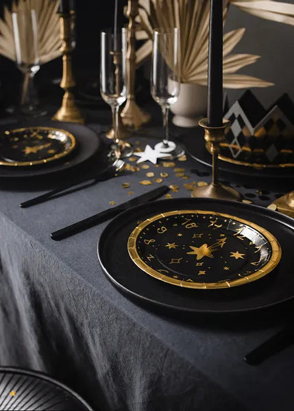 black and gold clock plates new years 2024