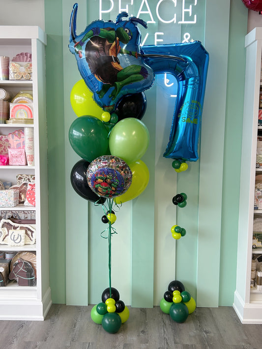 Ninja turtle birthday balloon bundle with themed foil balloons, green and black latex balloons and a personalized blue number 7 balloon.