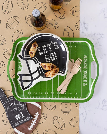Football-themed party table with #1 foam finger napkin, helmet plate, green field tray, and snacks, available in Toronto and shipping across Canada.