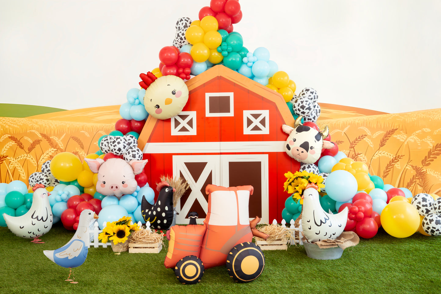 Farm-themed birthday backdrop with barn display and farm colourful balloons, available at our Toronto party shop.